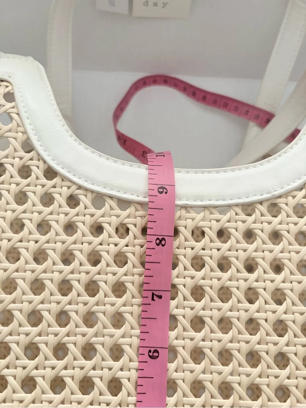 A New Day Straw Caning Tote Bag natural woven cane design white trim detailing.
